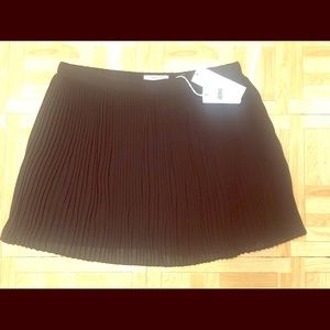 Naked Zebra black short pleated skirt L NWT